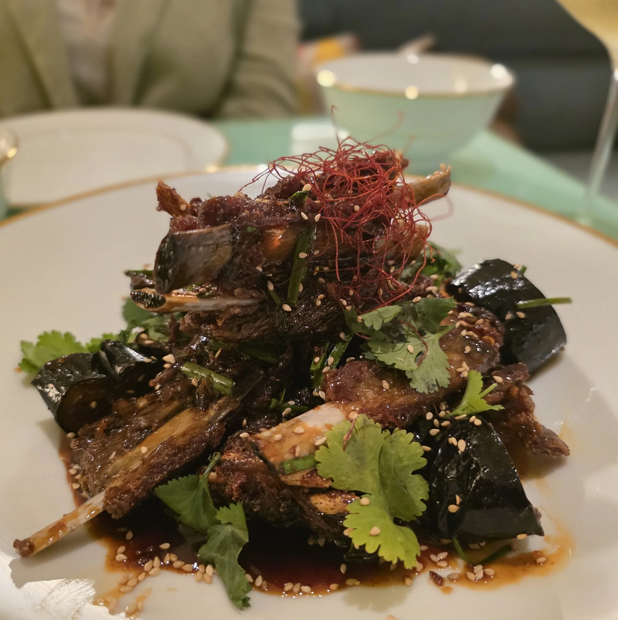 Sticky cumin Margra lamb riblets and eggplant.