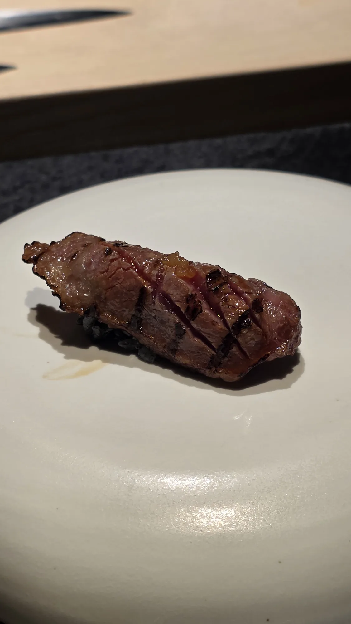 9+ wagyu sirloin nigiri on charcoal rice