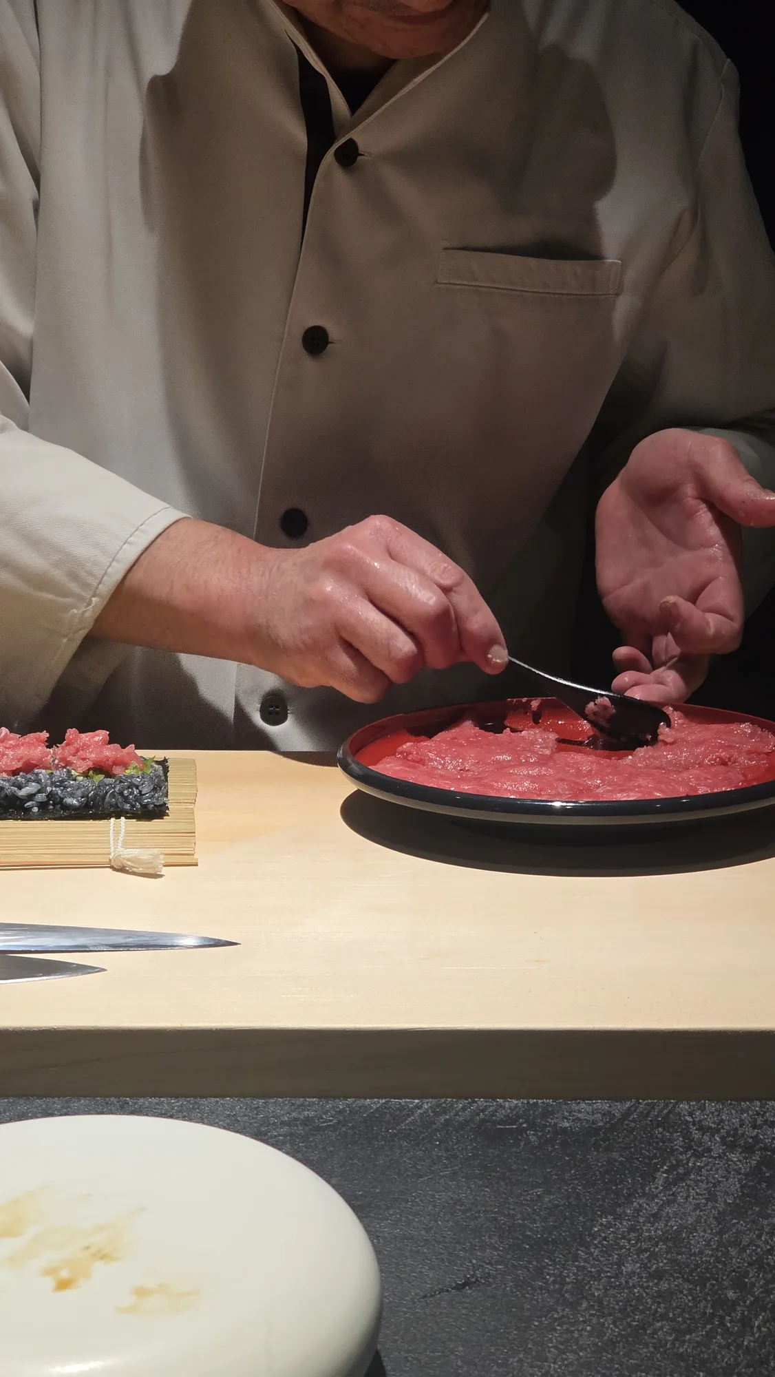 Chef rolling the maguro maki at the counter